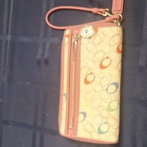 Coach white wristlet with pink trim and baby blue lined pockets